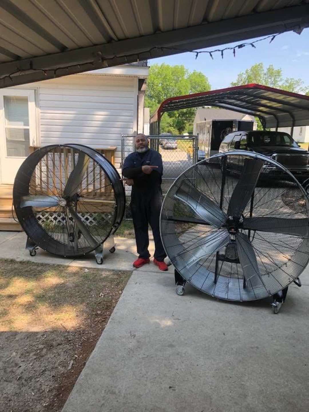Two large drum fans on rolling stands