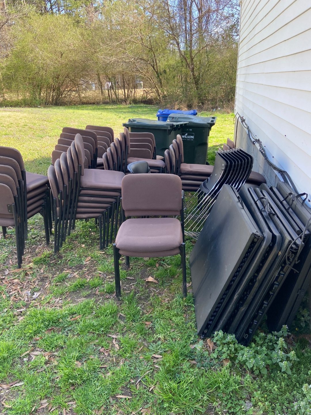 Stacks of padded chairs and folding tables